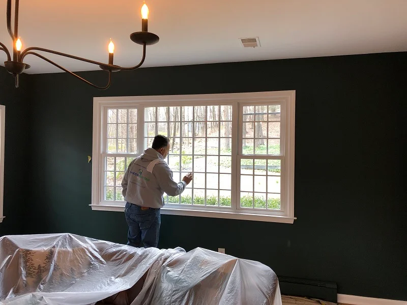 Window Solutions Plus Master installer cleaning the new windows installed in Redding, CT